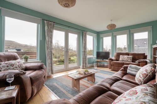 The light-filled sun room is a wonderful spot in which to gather and watch for birds.