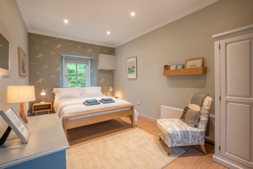 Discover a calming oasis in the master bedroom with beautiful sea views