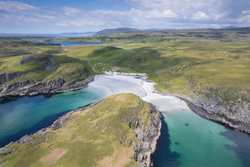Hike along this quiet coastline to discover stunning shell-sand beaches