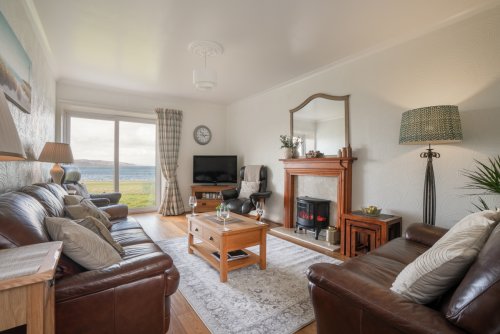 Relax in the spacious living room with stunning sea views at Tigh Bhan