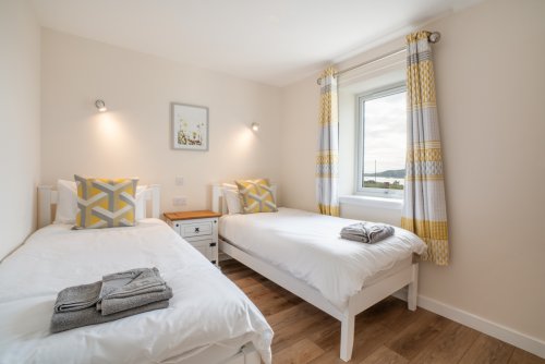 The well-appointed twin bedroom, complete with a sea view