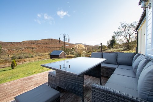 Decking with seating and table to the front of the property