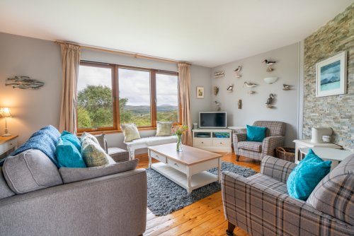 The beautifully presented living room with comfortable seating and electric stove