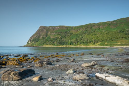 Wander down to the black sand beach at Carsaig Bay
