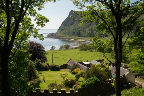 Looking over Carsaig Gardens to the beach and headland beyond