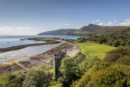The ruins of Moy Castle peek from the trees