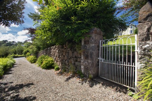 Path at the bottom of the garden starts your walk down to the sea